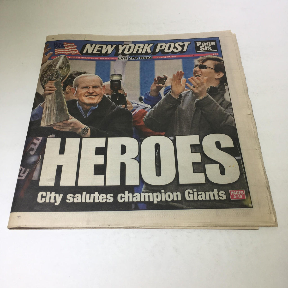 Front page of the New York Post from Feb 8, 2012, showcasing the headline 'HEROES' with images of people celebrating and saluting the champion Giants.
