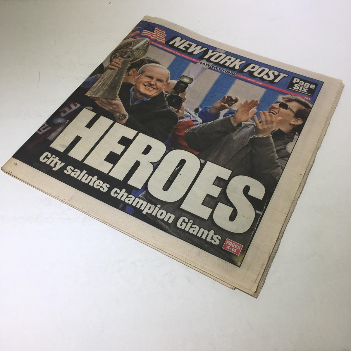 Front view of the New York Post dated Feb 8, 2012, with the headline 'HEROES' celebrating the champion Giants, showing jubilant crowd reactions.
