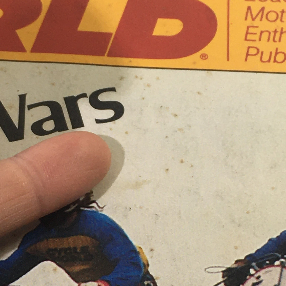 Close-up view of the Cycle World Magazine June 1978 cover highlighting 'Four-Star Wars', with a finger pointing to the title on the magazine.