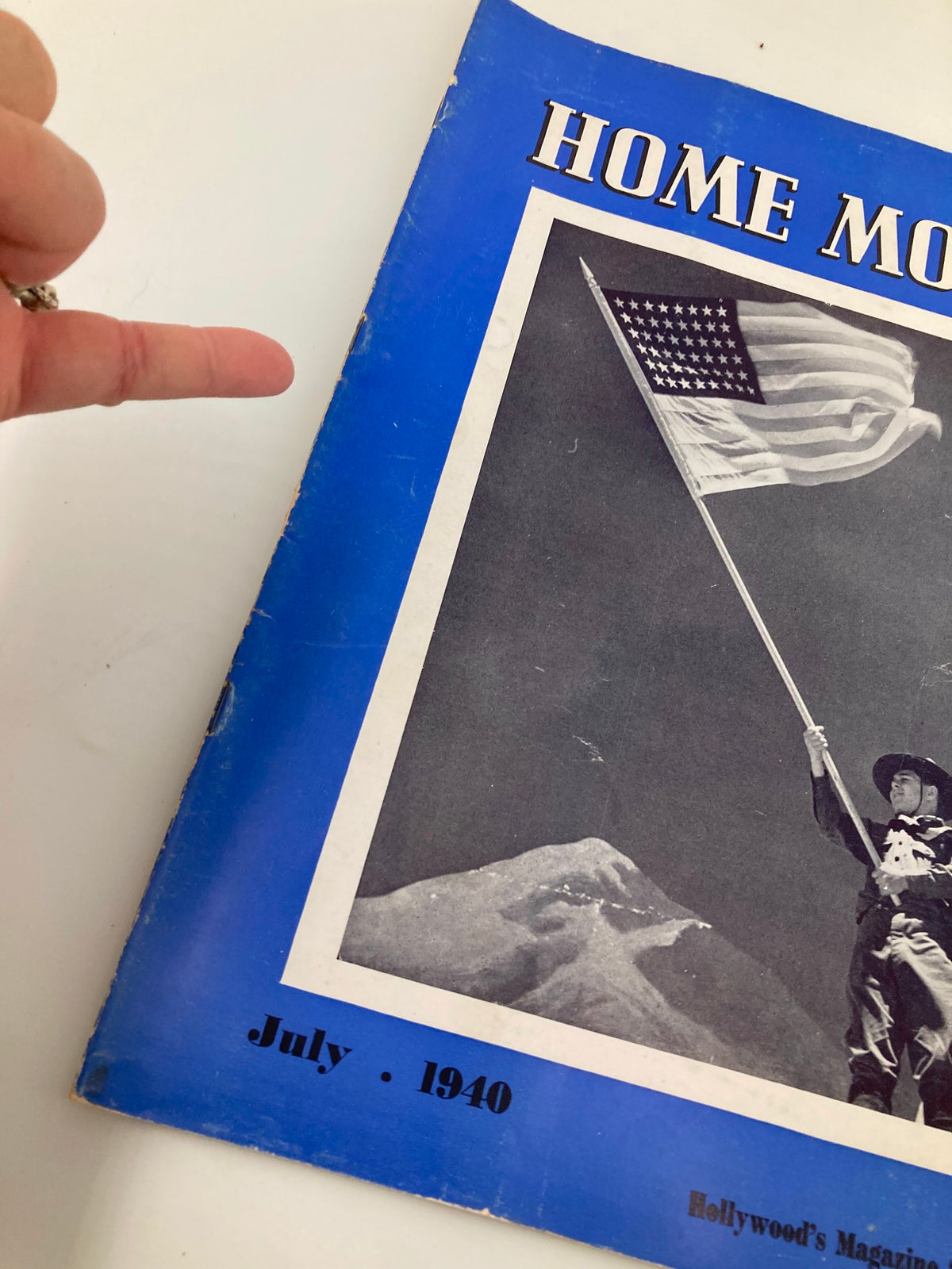 Cover of the VTG Home Movies Magazine July 1940 showcasing an image of a person holding an American flag against a mountain backdrop.
