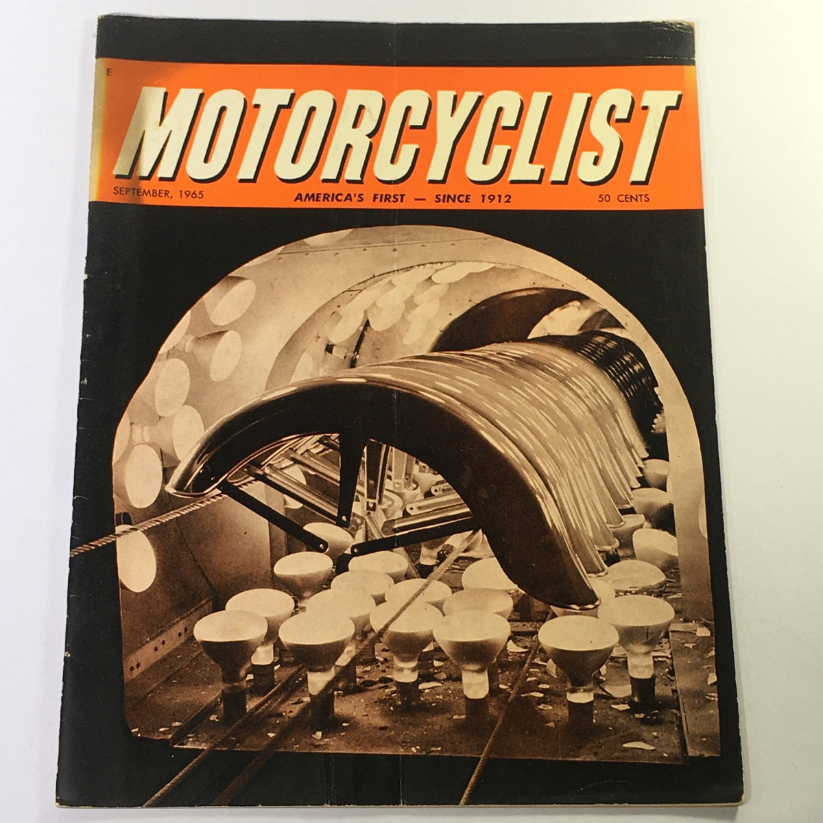 Cover of VTG Motorcyclist Magazine September 1965 showcasing a vintage motorcycling theme with an iconic design featuring a motorcycle exhaust system and classic typography. This magazine includes features on Greeves Trials and BSA 1965 scooters.
