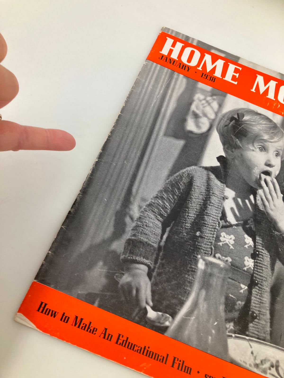 Close-up of the VTG Home Movies Magazine January 1938 cover showing a child and details about making educational films, emphasizing vintage cinema and movie tricks.