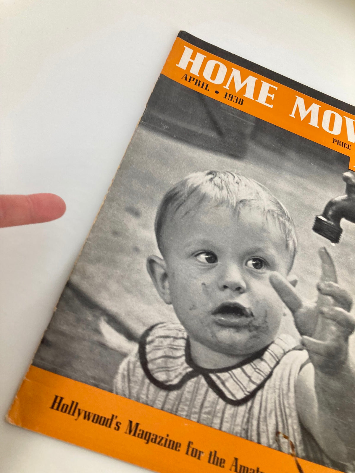 Close-up view of the cover of VTG Home Movies Magazine April 1938, highlighting a child's face with dirt, the magazine title 'Home Movies', and the phrase 'Hollywood's Magazine for the Amateur'.