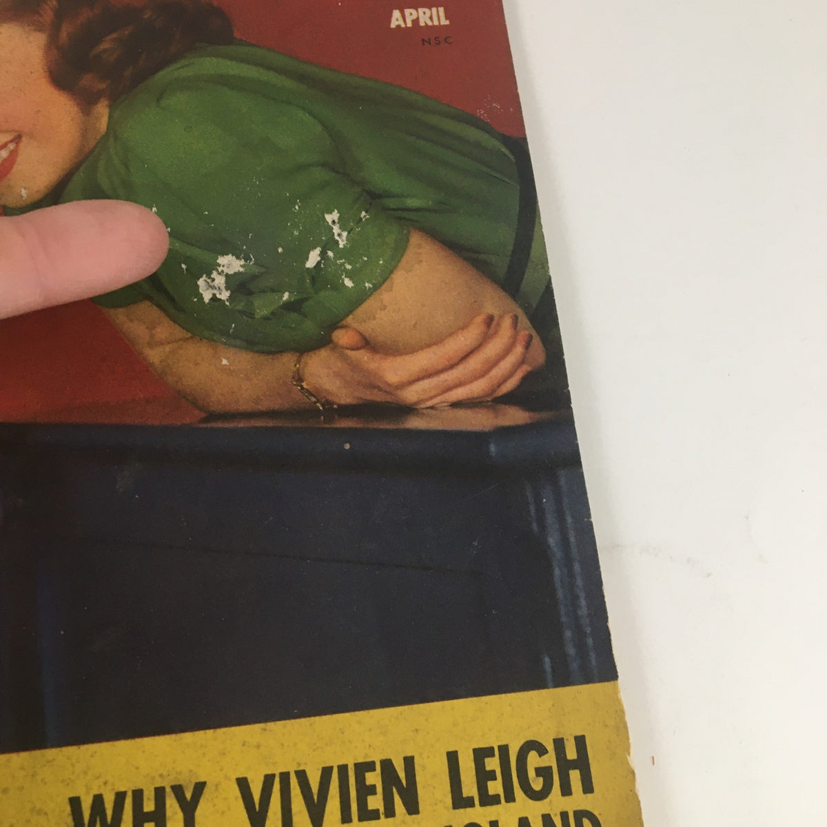 Detailed image of the April 1941 Motion Picture Magazine cover showcasing remnants of wear and an elegant green outfit, signifying its nostalgic value and classic Hollywood charm.