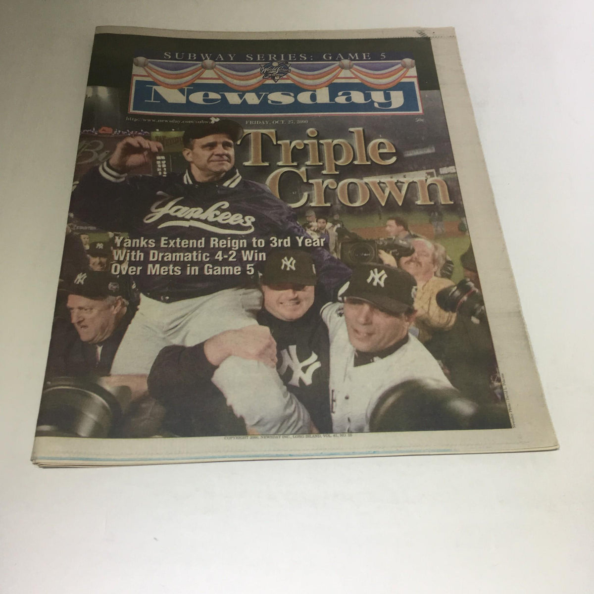 Cover of Newsday newspaper featuring the headline 'Newsday: 10/27/2000 Yanks Extend Reign 2 3rd Yr W/ 4-2 Win Over Mets in Game 5' with image of Yankees players celebrating.