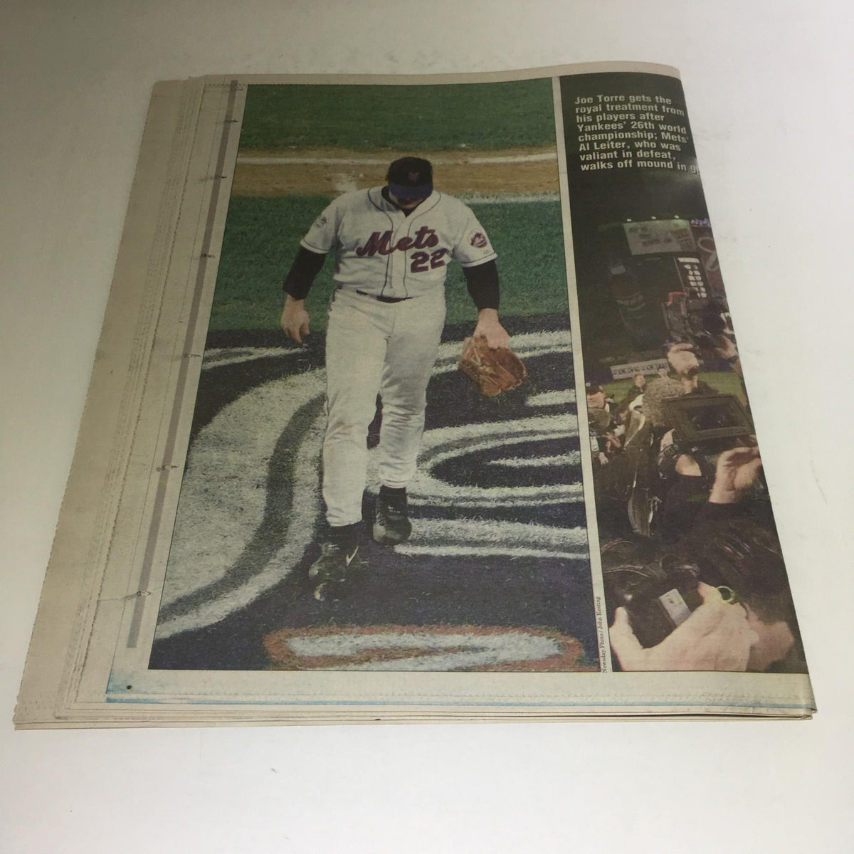 Backside view of a New York Mets player walking off the field, from the October 27, 2000 issue of Newsday with the title 'Newsday: 10/27/2000 Yanks Extend Reign 2 3rd Yr W/ 4-2 Win Over Mets in Game 5'.