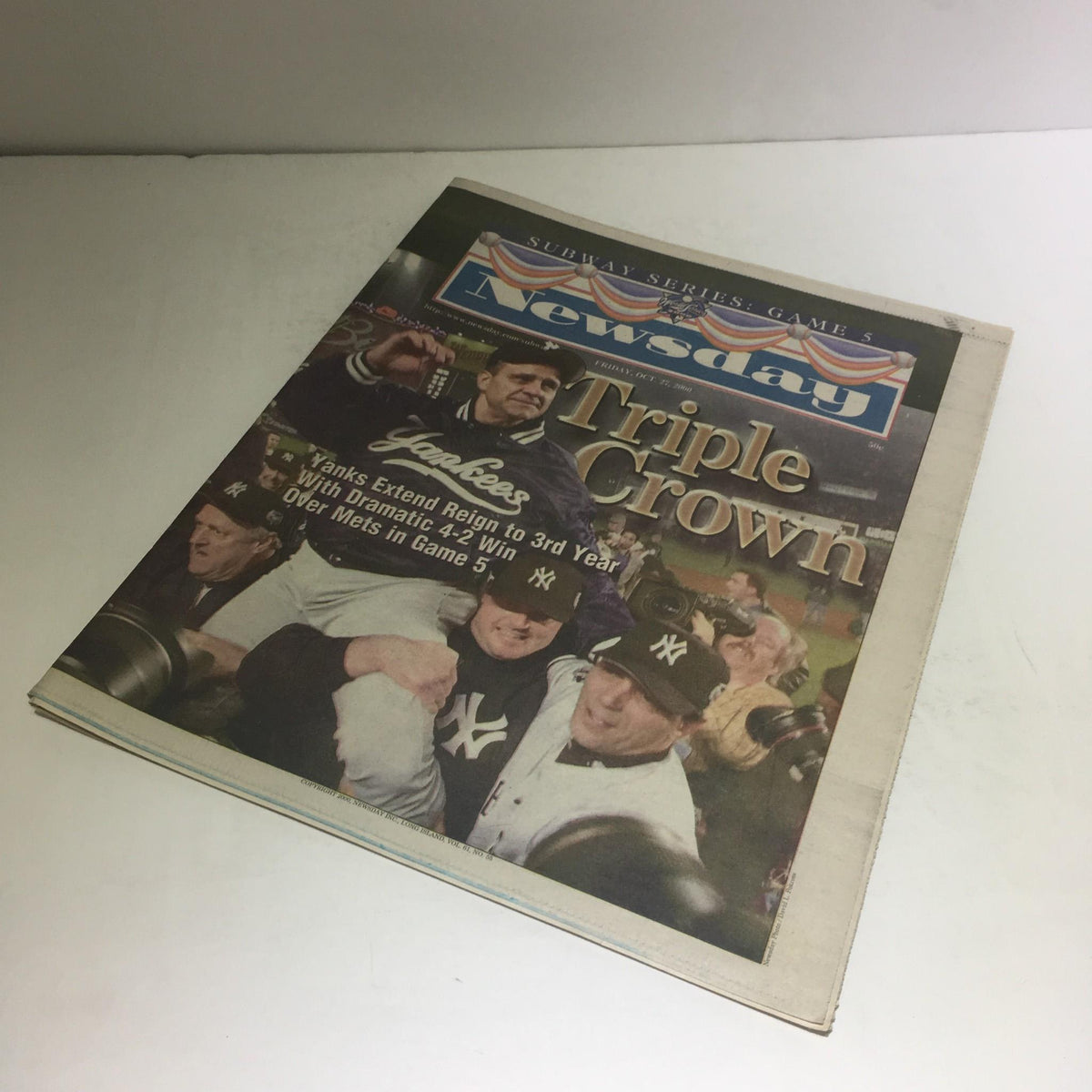 Another view of the Newsday cover showcasing 'Newsday: 10/27/2000 Yanks Extend Reign 2 3rd Yr W/ 4-2 Win Over Mets in Game 5' with Yankees players celebrating their victory.
