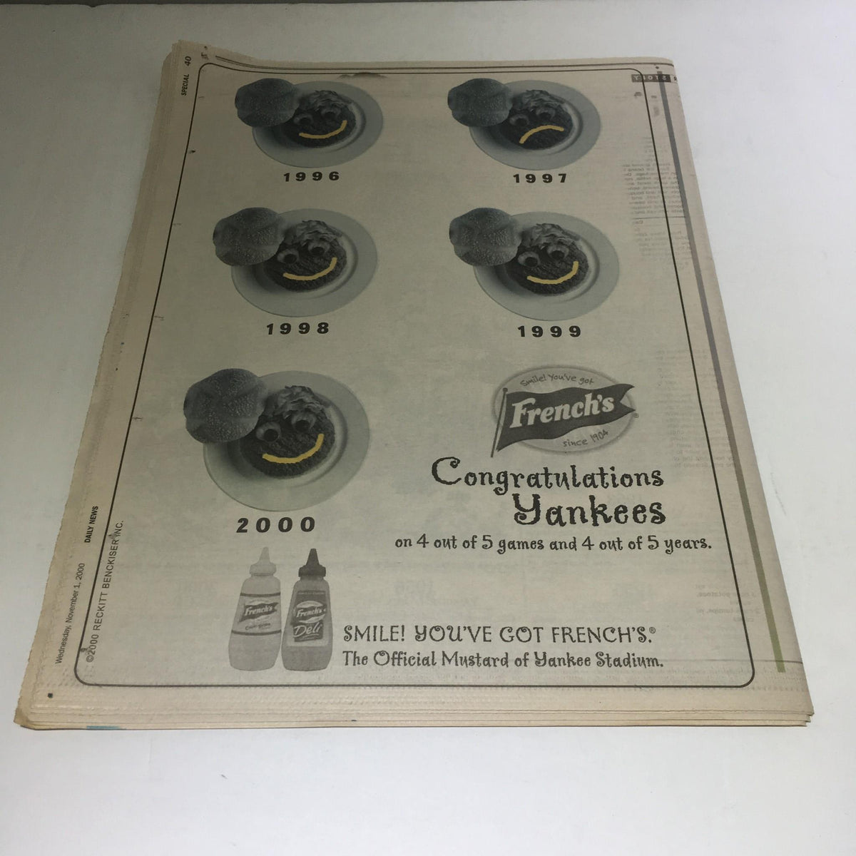 NY Daily News: Nov 1 2000 A Subway Season, Excellent - A newspaper advertisement congratulating the Yankees with images of baseballs for the years 1996, 1997, 1998, 1999, and 2000, highlighting their success.