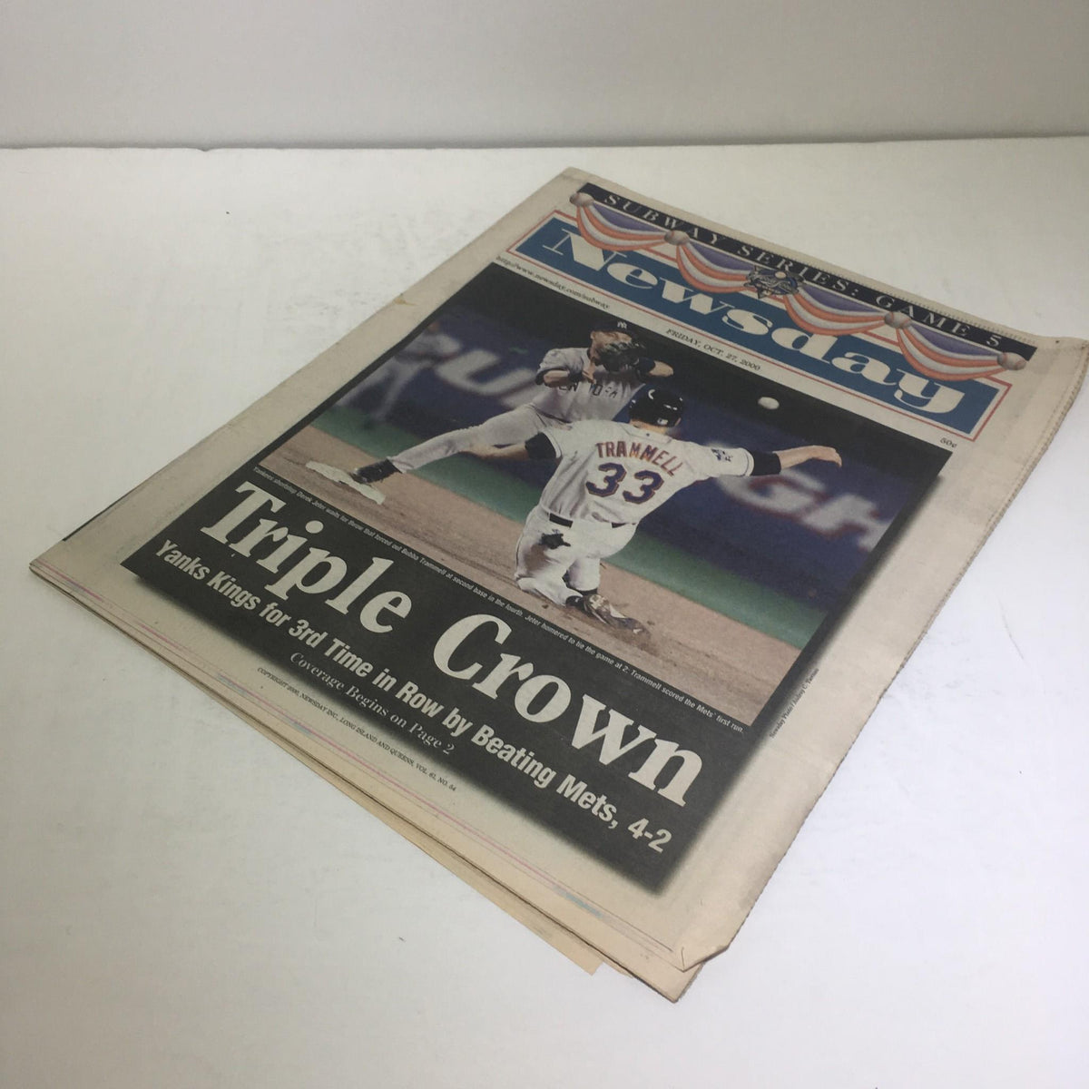Another view of the front cover of Newsday from October 27, 2000, showcasing the 'Triple Crown' headline about Yankees beating Mets.