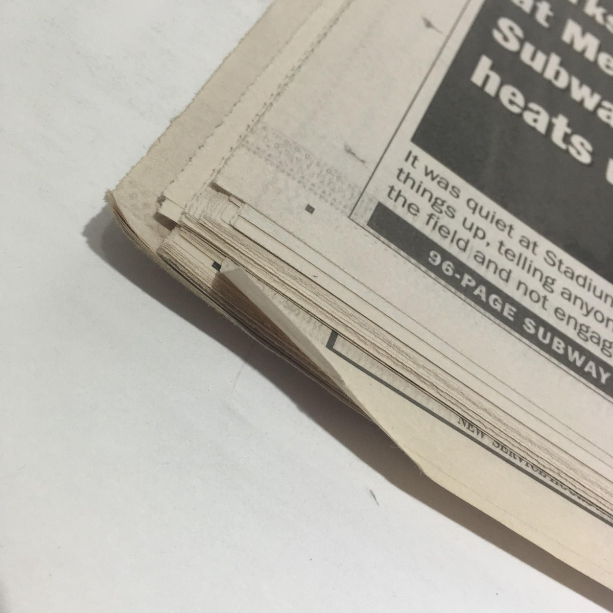 Close-up view of the edge of a newspaper featuring the title 'NY Daily News: Oct 27 2000 Ready To Rumble,' showing mild wear with aged pages.