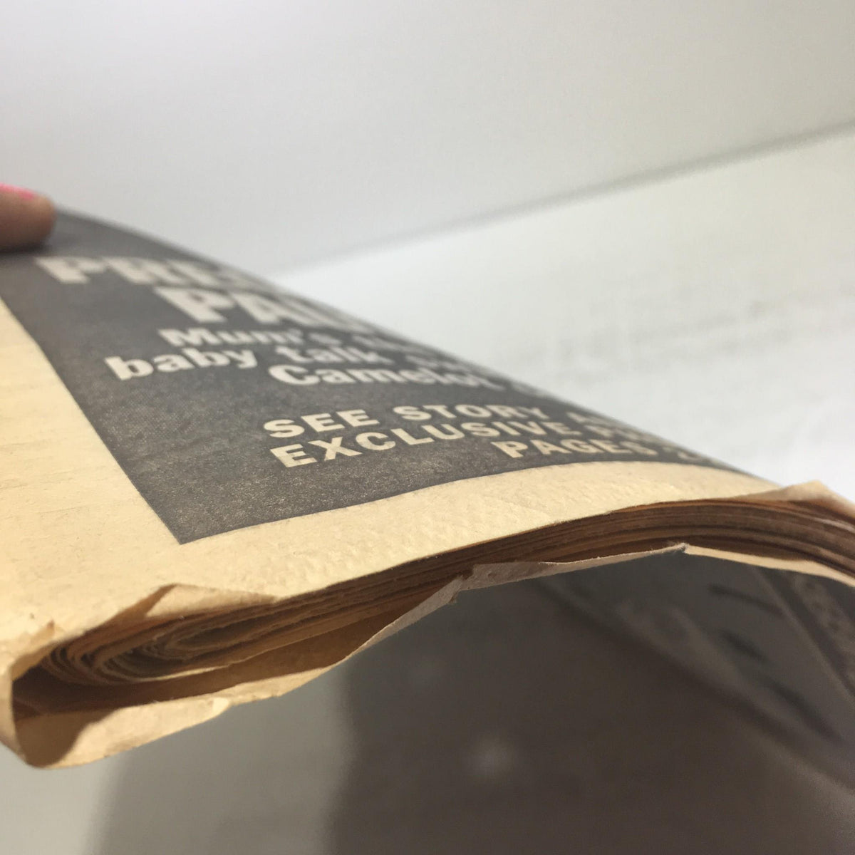 Close-up view of the spine of the New York Daily News from October 24, 1996, titled 'We'll Yank Their Chain', showcasing the aged paper and its delicate condition.