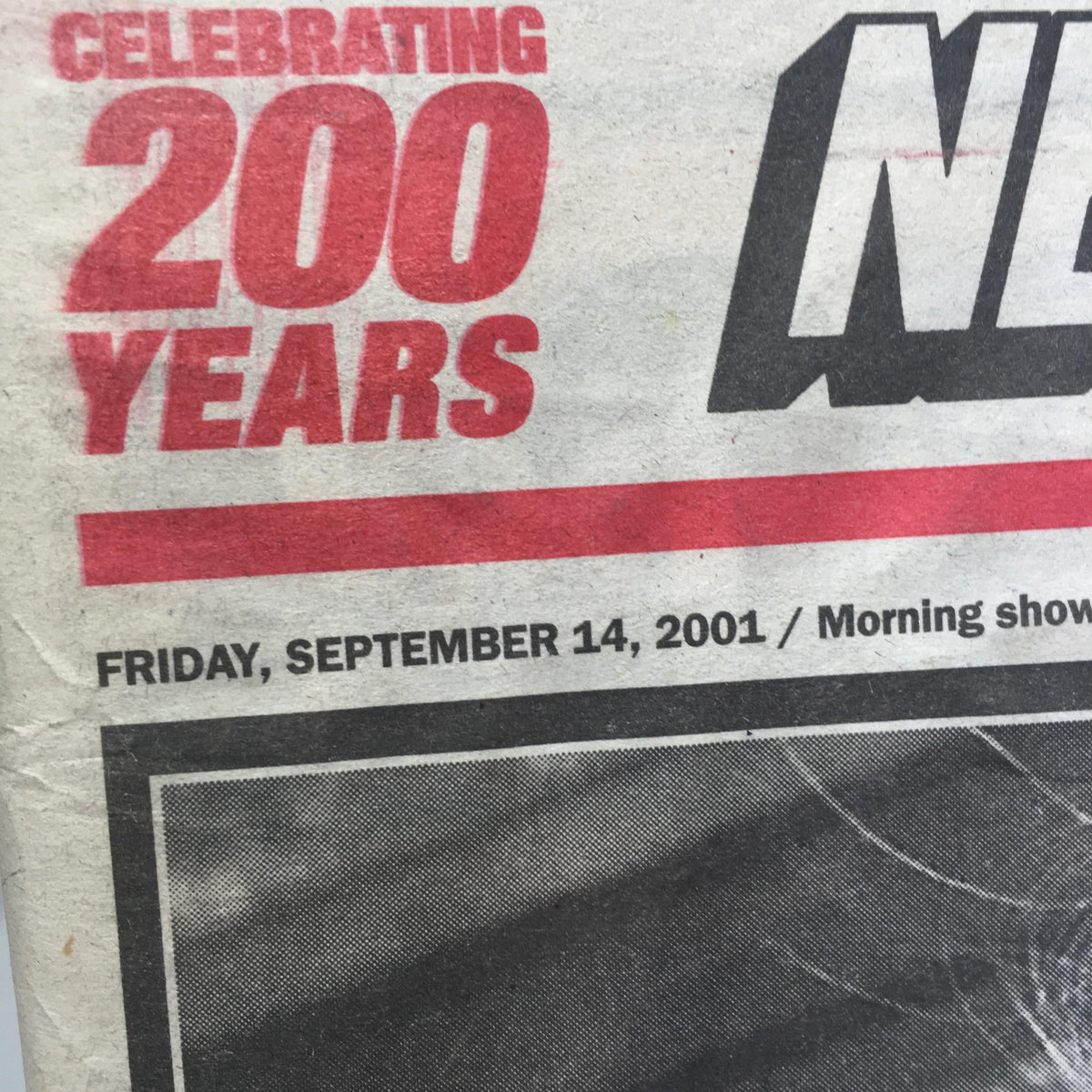 Close-up of the New York Post dated September 14, 2001, showcasing the celebration of its 200 years. The date and the impactful headline 'New York's Tragic Face' highlight a significant historical moment.