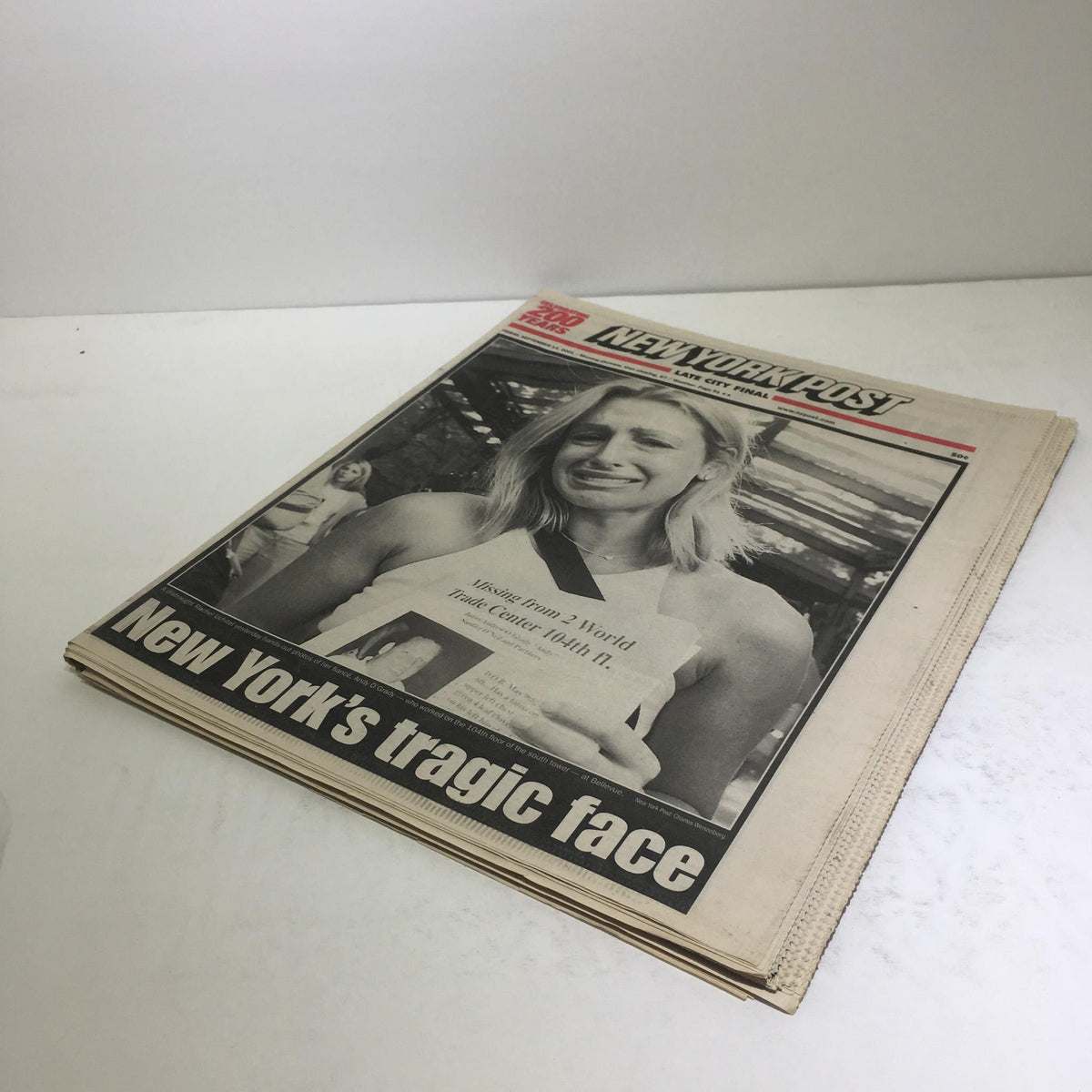 Secondary cover of the New York Post with the title 'New York's Tragic Face,' depicting a solemn moment reflecting the events of September 11, 2001.