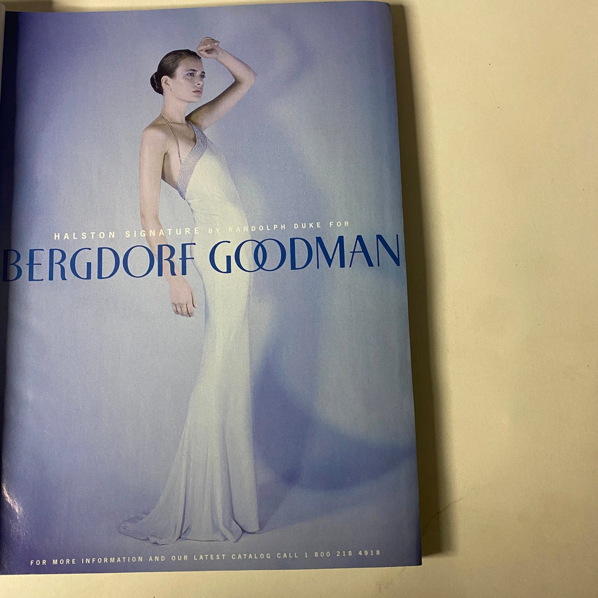 Another interior page from Vogue Magazine December 1997 showcasing a Halston Signature advertisement for Bergdorf Goodman, displaying elegant fashion design.