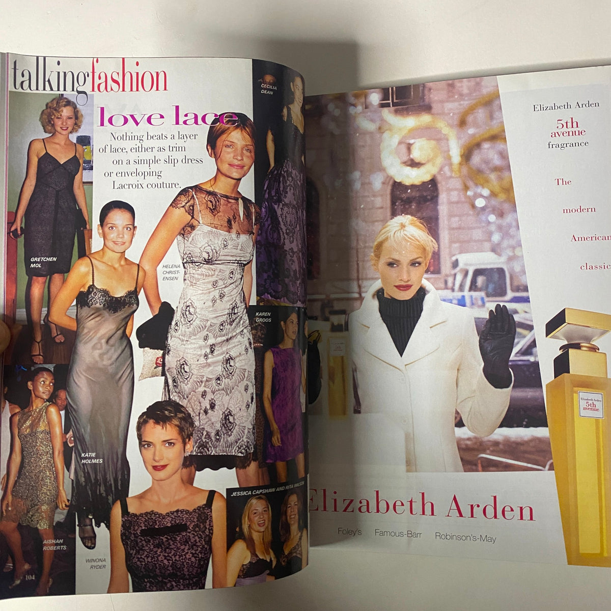 Interior spread from Vogue Magazine December 1997 featuring fashion models in elegant lace dresses and a feature on Elizabeth Arden's new fragrance, showcasing the sophistication and style of the late 1990s.