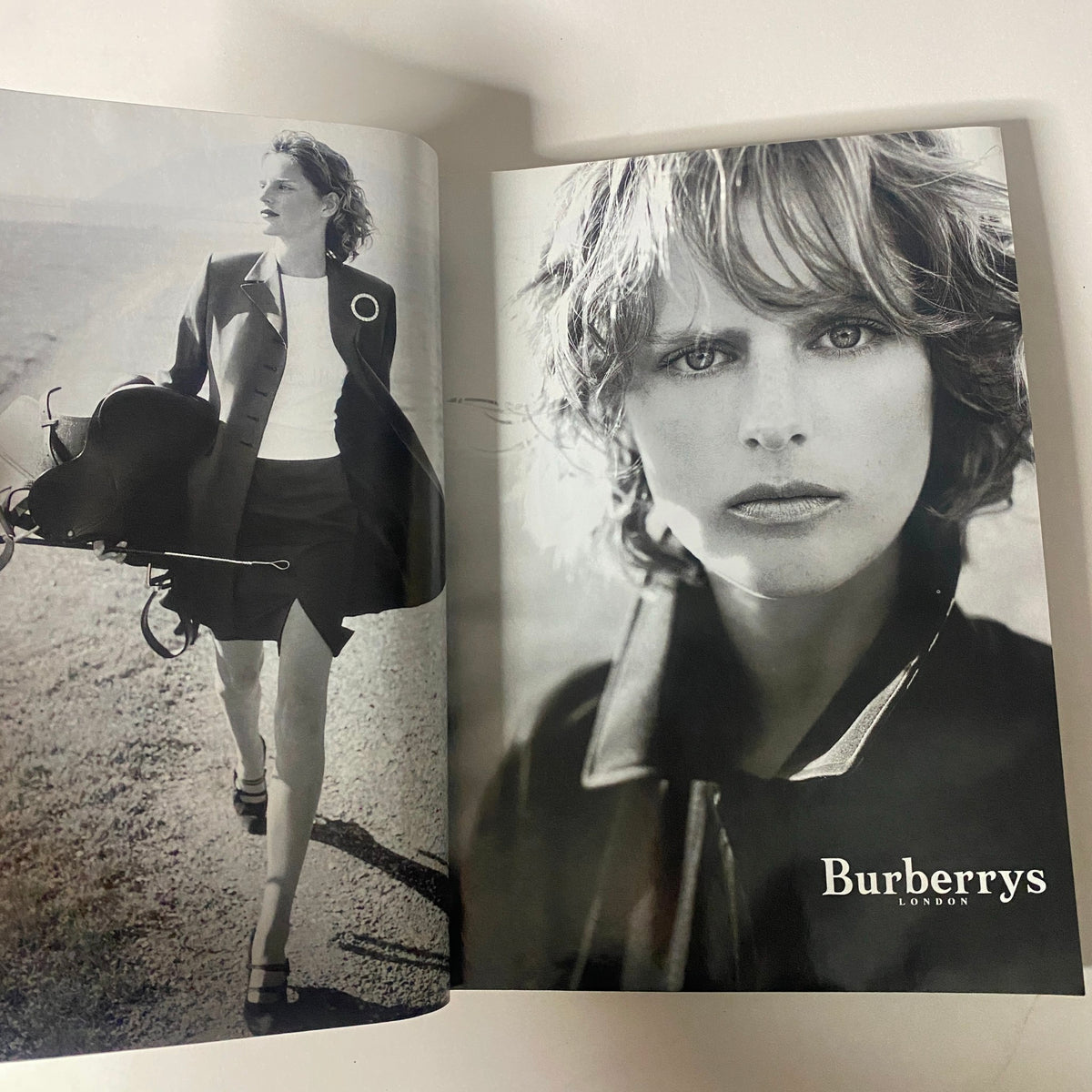 Vogue Magazine March 1998 showcasing an advertisement for Burberry, featuring a model in outdoor fashion attire, emphasizing the brand's elegance and style.