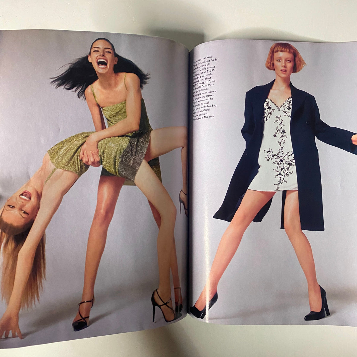 Two models featured in an editorial from July 1997 Vogue Magazine, showcasing bold fashion looks and designs from the era.