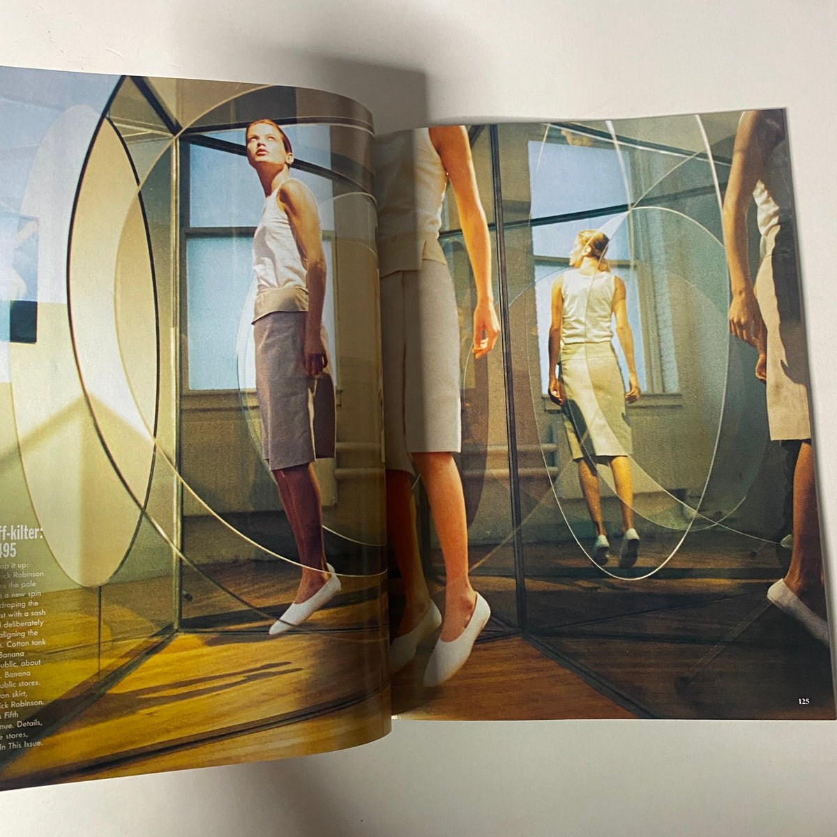 Vogue Magazine January 1998 featuring a model amidst reflective circles, showcasing minimalist fashion in very good condition. Captures iconic designs and aesthetics of the late '90s.