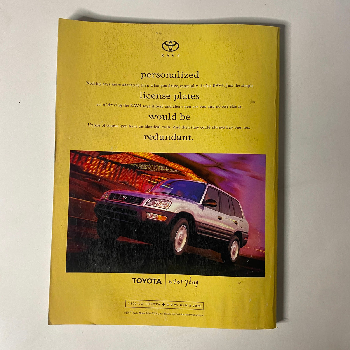 Advertisement page from Vogue Magazine February 1998 for the Toyota RAV4, highlighting personalized license plates.