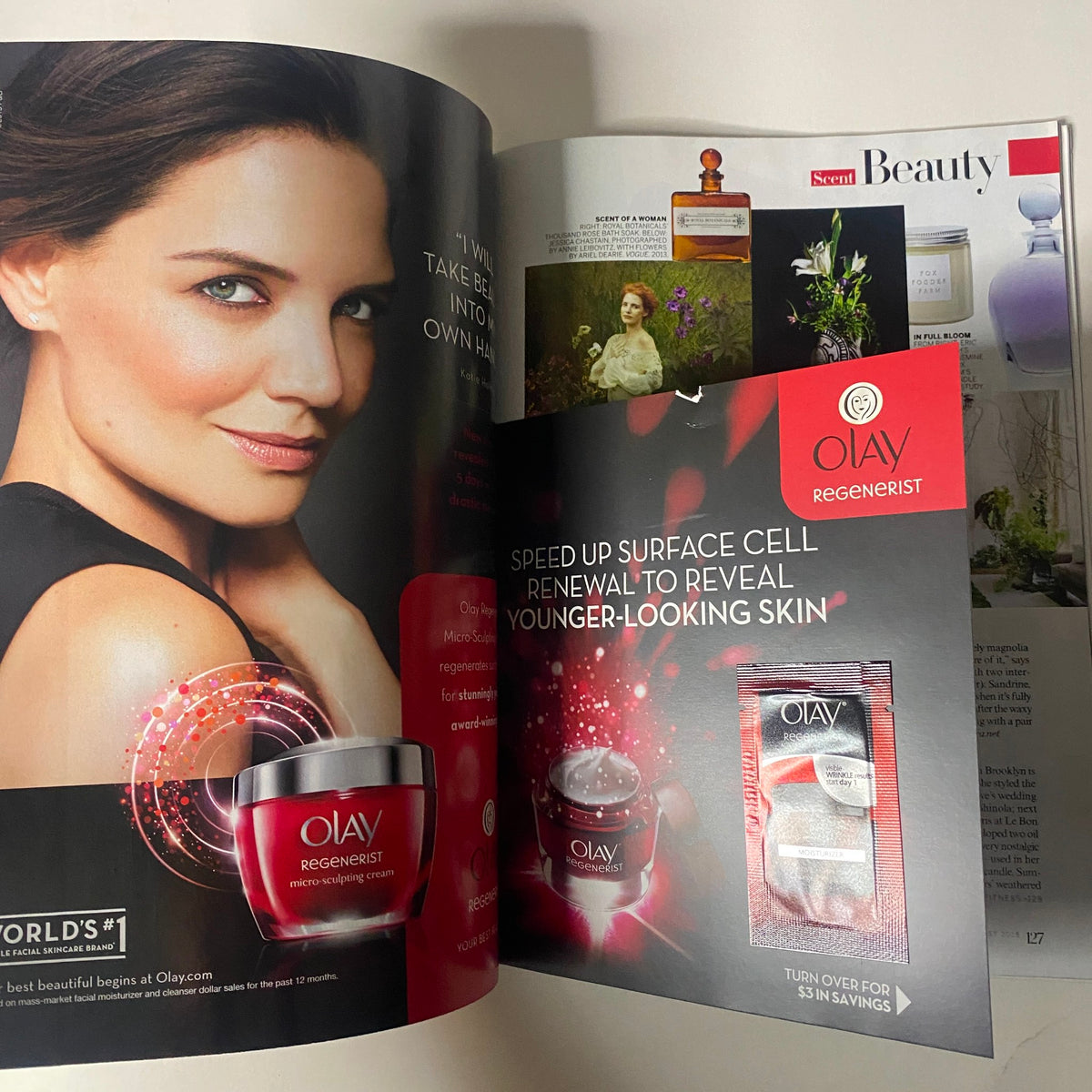 An advertisement featuring Olay Regenerist skincare products from Vogue Magazine August 2015 with Nicole Kidman on the cover. The image showcases a glamorous model promoting youthful skin with bold makeup.