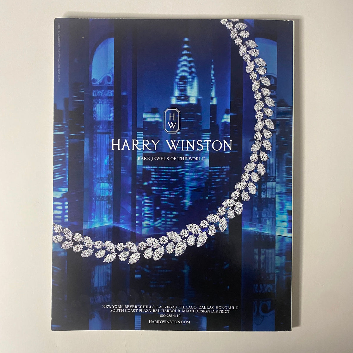 Back cover of Vogue Magazine 2015 featuring a luxurious advertisement for Harry Winston showcasing rare jewels against a city skyline. Vogue Magazine 2015 Rihanna Cover for Met Gala No Label VG.