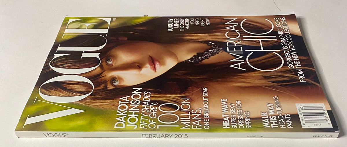 Side view of Vogue Magazine February 2015 Dakota Johnson Cover, displaying the magazine's title and a close-up of the cover featuring Dakota Johnson's portrait and promotional text about her role in Fifty Shades of Grey.