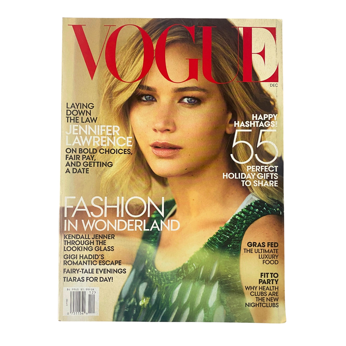 Vogue Magazine December 2015 featuring Jennifer Lawrence on the cover, showcasing her beauty and style. The cover also highlights articles on bold fashion choices and holiday gifts, accompanied by a striking photo of Lawrence.