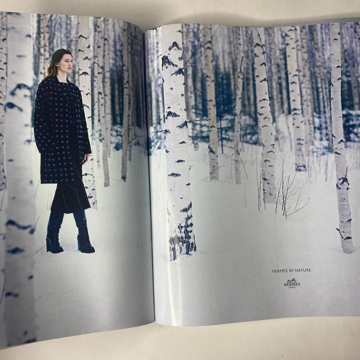 Vogue Magazine September 2016 ad spread featuring a model in a high-fashion outfit amidst a snowy birch forest.