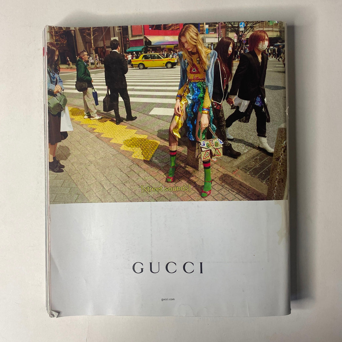 Vogue Magazine September 2016 cover showcasing a fashion model in edgy Gucci attire, set against a busy urban backdrop.