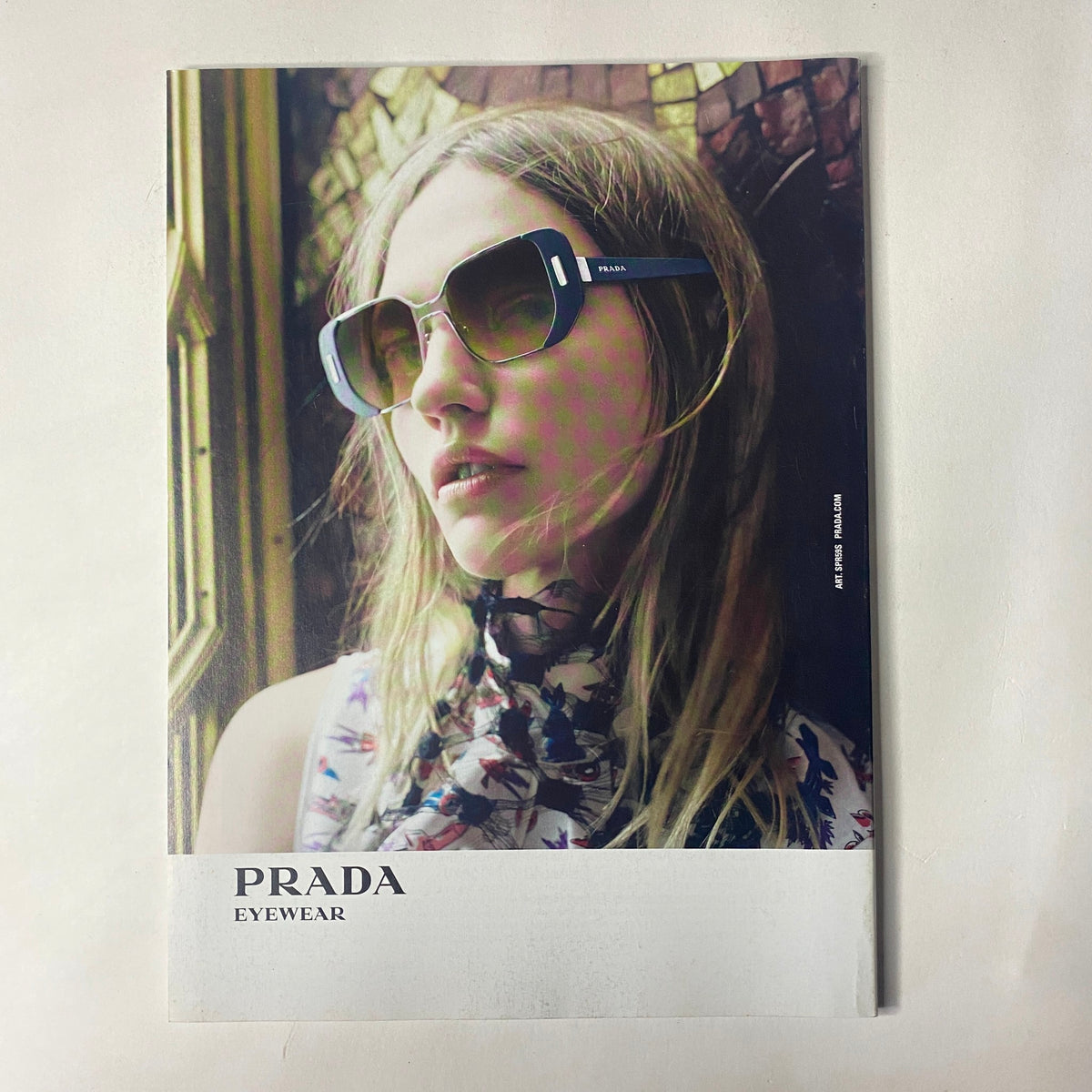 Vogue Magazine June 2016 Margot Robbie Cover includes a vibrant photograph of a woman modeling Prada eyewear, highlighting contemporary fashion in a summer setting.
