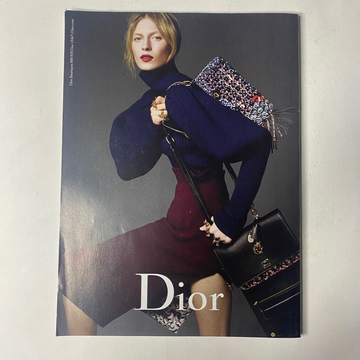 Vogue Magazine August 2016 advertisement for Dior, displaying a model in elegant attire accessorized with a chic handbag, embodying high fashion aesthetics.