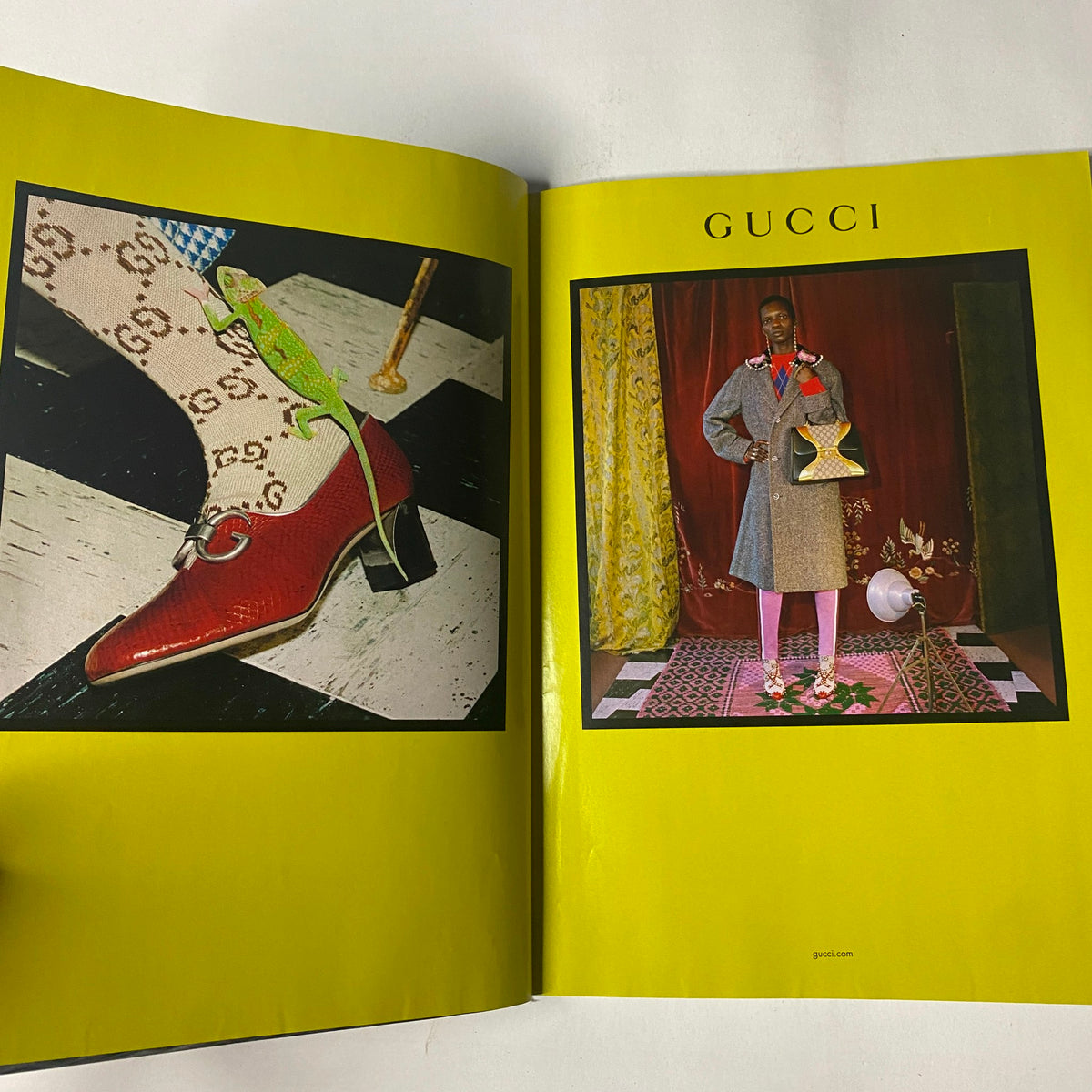 Gucci advertisement featuring a model in a stylish outfit and red shoes, surrounded by unique decor, from Vogue Magazine August 2017 with Gigi Hadid and Zayn Malik on the cover.