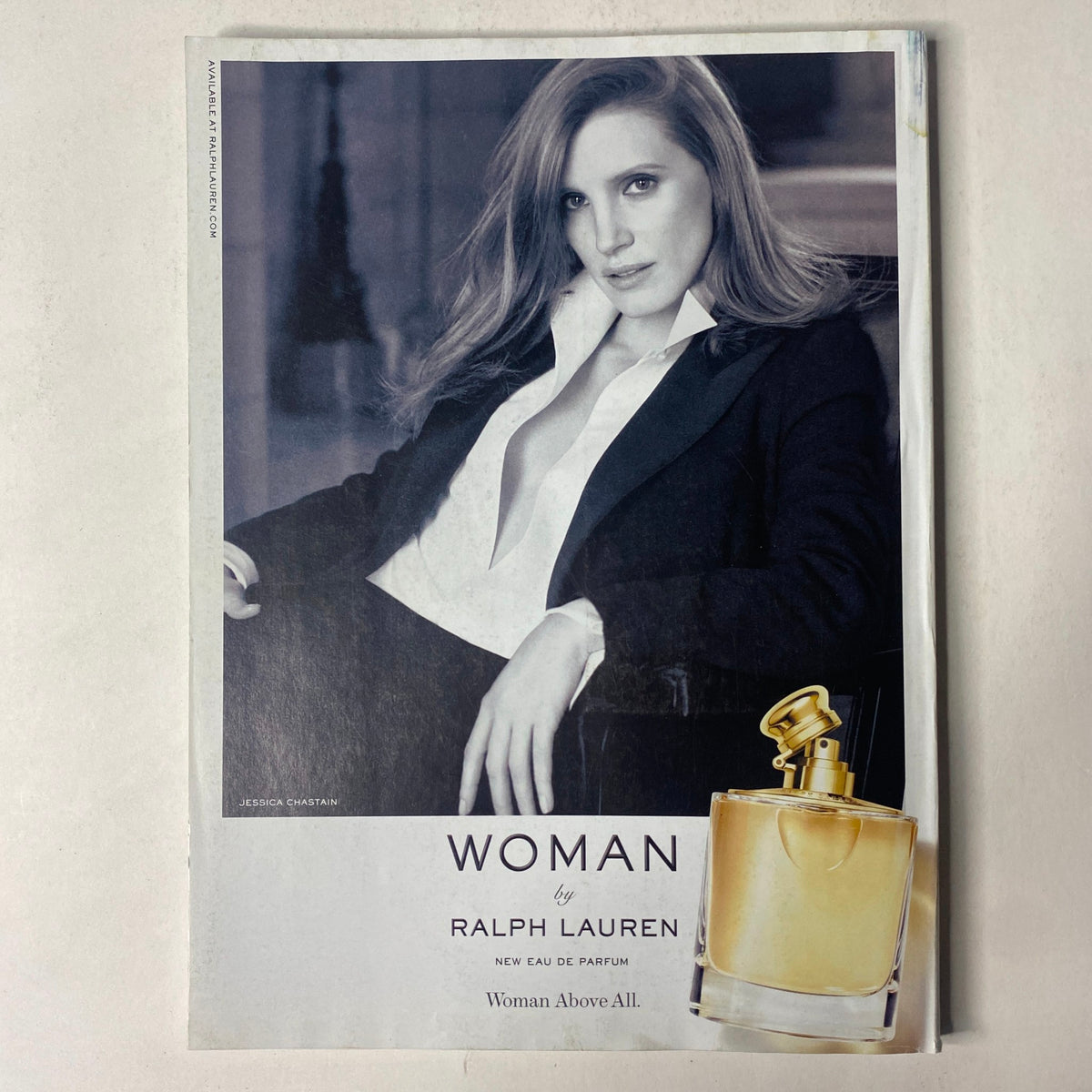 Advertisement page from Vogue Magazine November 2017 for Ralph Lauren's 'Woman Above All' perfume featuring a model, complementing the overall luxury theme of the issue with Daisy Ridley.