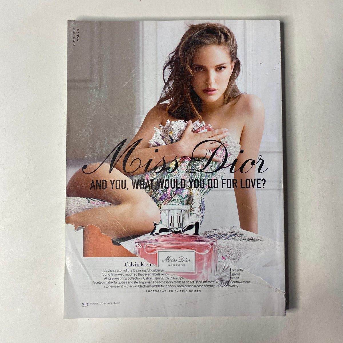 Cover advertisement for Miss Dior in Vogue Magazine October 2017 featuring a model modeling the perfume with an elegant expression.
