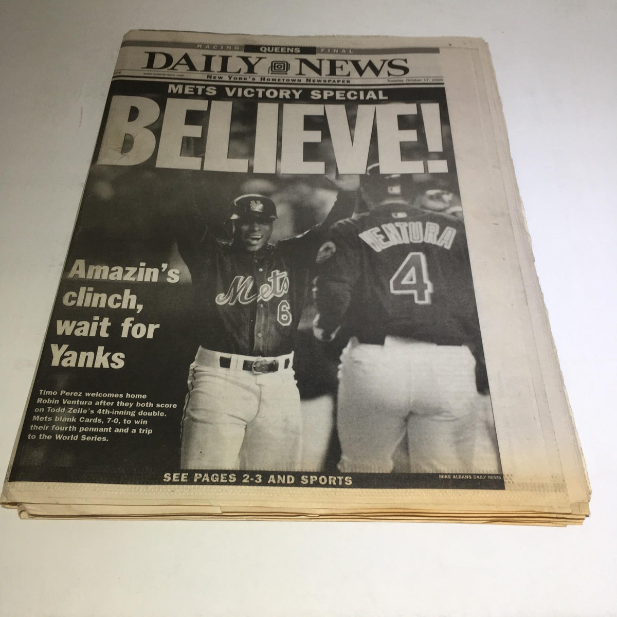 NY Daily News front page from October 17, 2000, featuring the headline 'Believe! Amazin's clinch, wait for Yanks' with a photo of Mets players celebrating their victory.