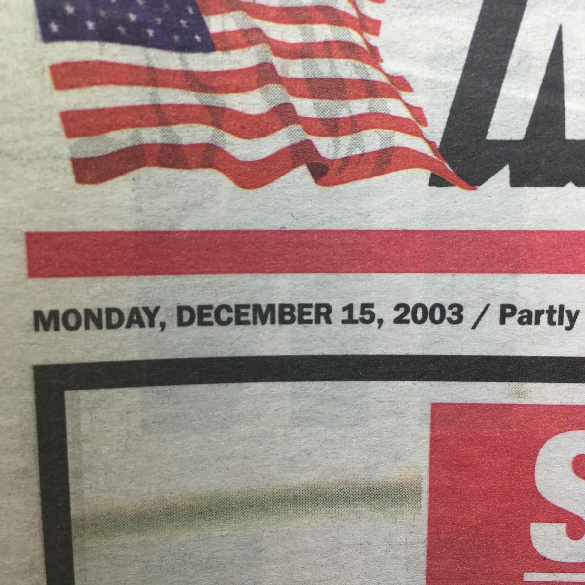 Date section of the New York Post, December 15, 2003, noting the publication date alongside an American flag motif.