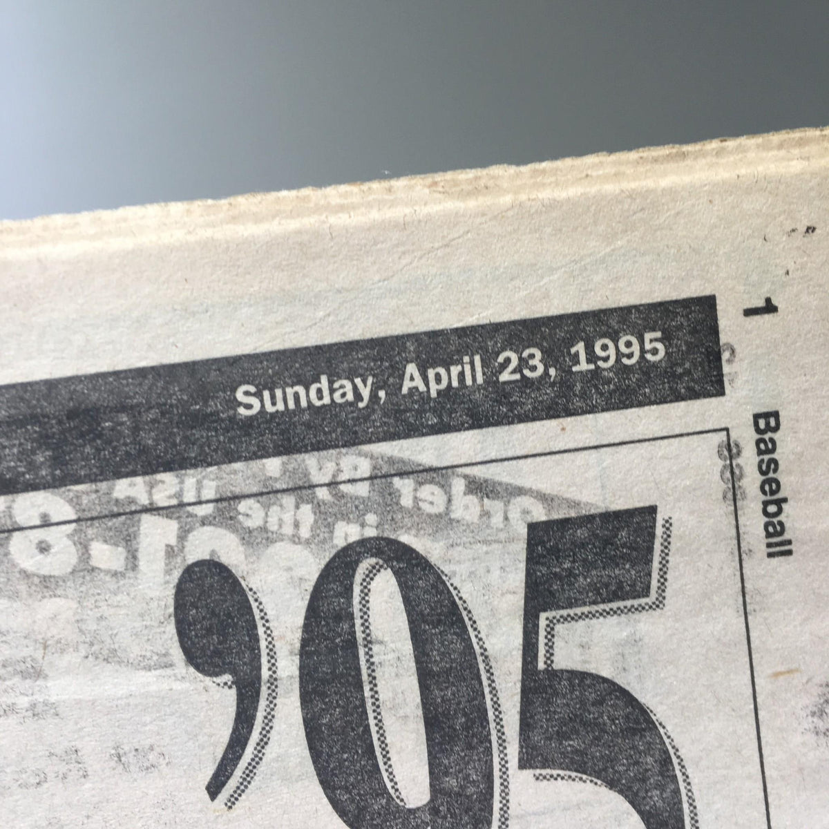 Close-up of the NY Daily News dated Sunday, April 23, 1995, featuring the date prominently displayed at the top of the newspaper.