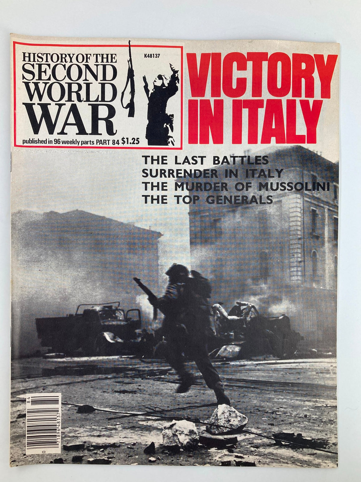 Cover of VTG History of the Second World War Part 84 1979 - Victory in Italy, showcasing a soldier carrying a rifle amidst a war-torn landscape. The cover highlights key themes including 'The Last Battles', 'Surrender in Italy', and 'The Murder of Mussolini', emphasizing the significant military events in Italy during WWII.