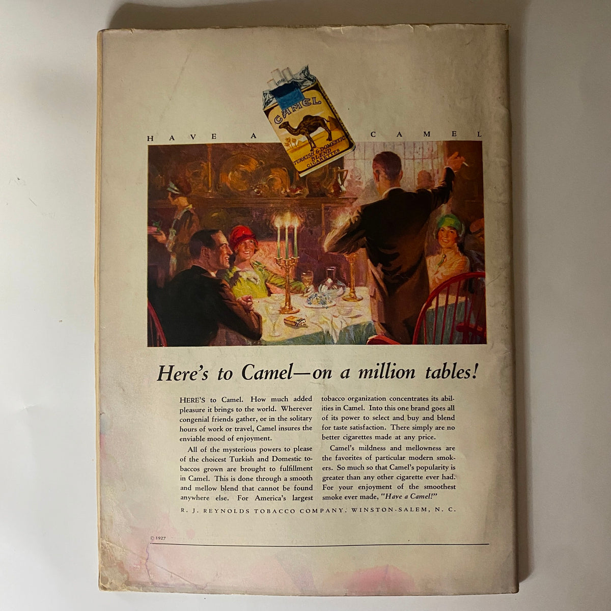 Back cover of The New Yorker Complete Magazine November 5, 1927 featuring an advertisement for Camel cigarettes, illustrating a dinner scene with patrons enjoying a meal.