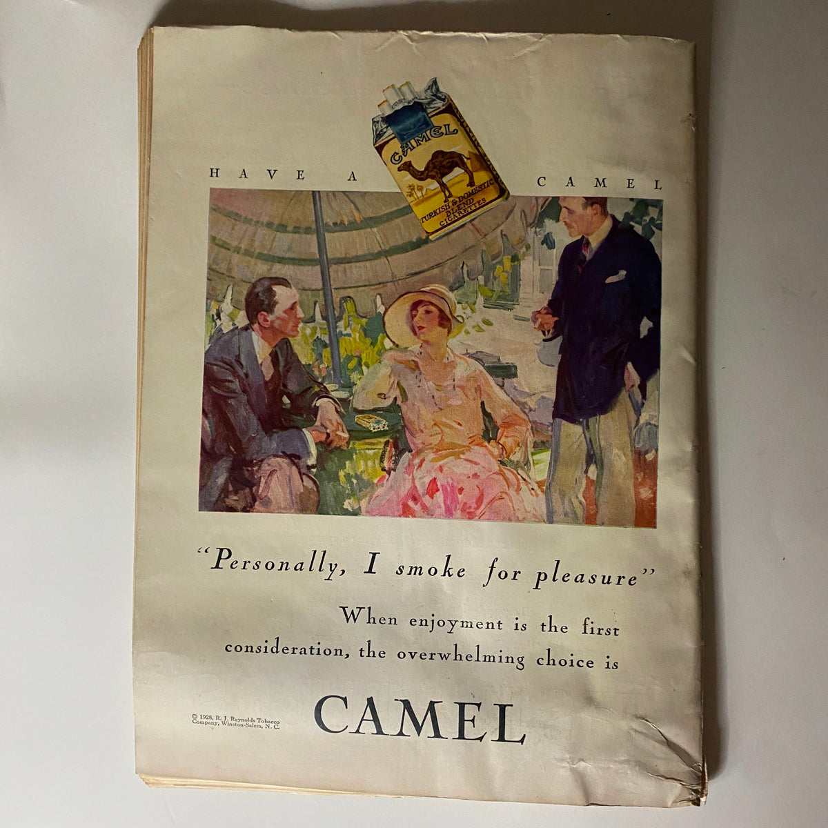 Classic Camel cigarette advertisement from The New Yorker Complete Magazine July 14, 1928, depicting a stylish scene with patrons enjoying leisure time, highlighting the brand's appeal.