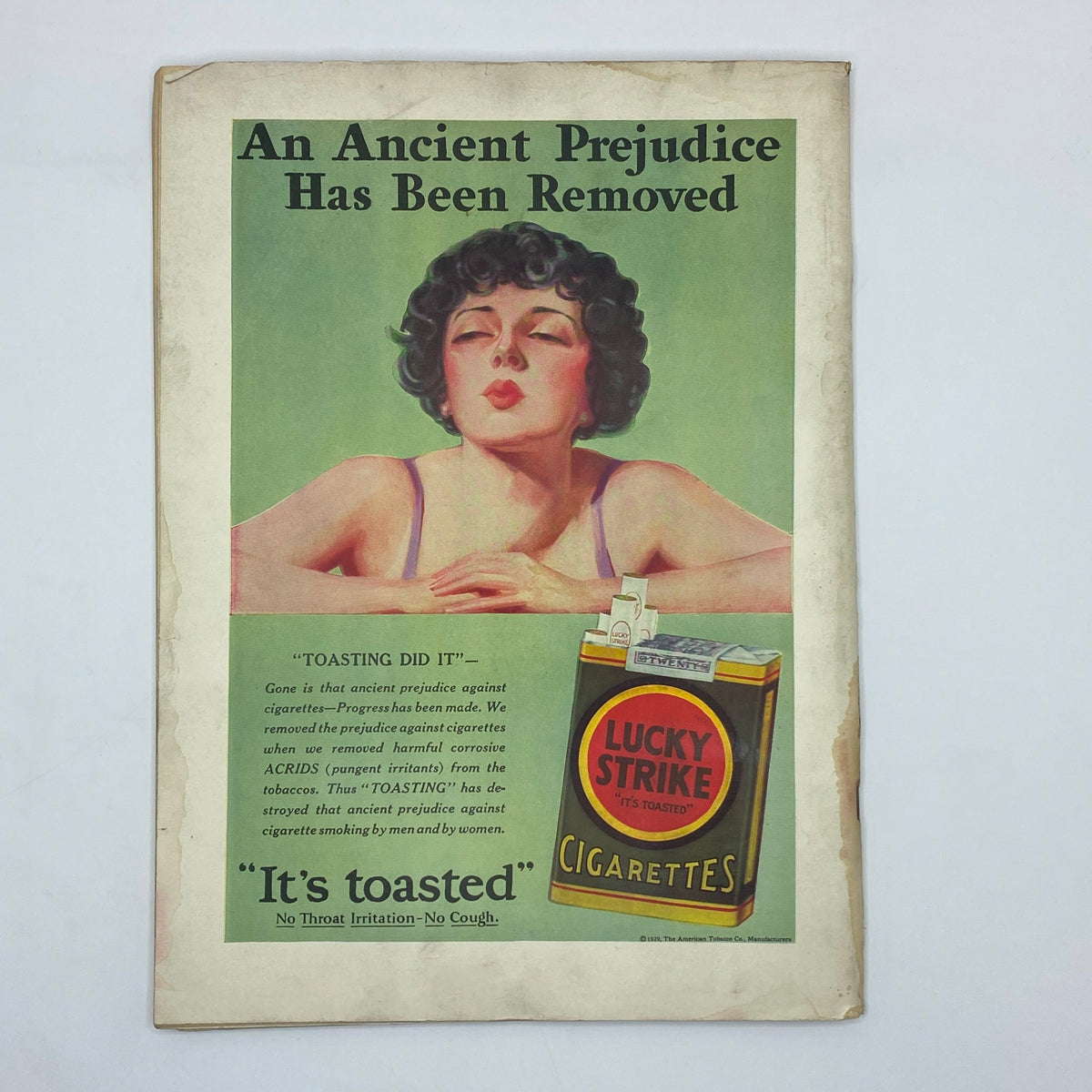 An advertisement featuring a woman with a retro hairstyle and a cigarette pack of Lucky Strike, with the tagline "An Ancient Prejudice Has Been Removed" and emphasizing that "It's toasted", from The New Yorker Complete Magazine – November 9, 1929.
