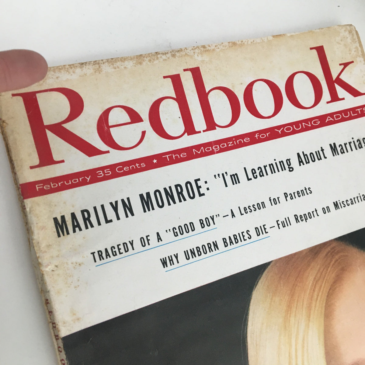 Front cover of Redbook Magazine February 1958 featuring Marilyn Monroe, highlighting the title and details of the issue along with her iconic hairstyle.