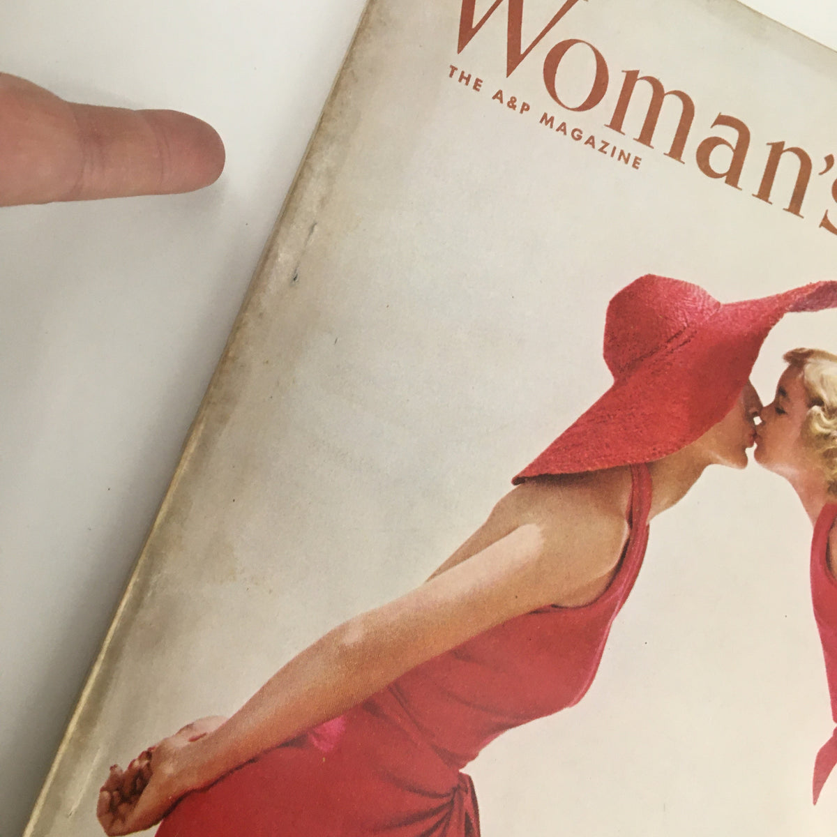 Close-up of the cover of Woman's Day Magazine June 1953, focusing on the vibrant red hats of a woman and girl, highlighting the issue's vintage appeal.