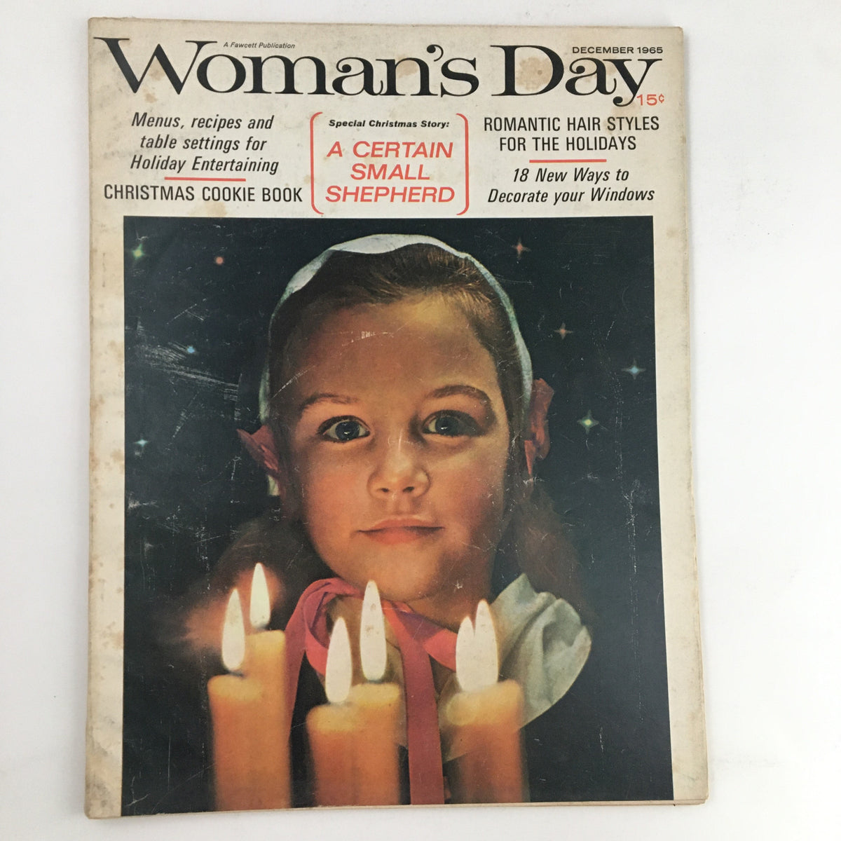 Woman's Day Magazine December 1965 cover featuring romantic hairstyles for the holidays, with a young girl holding candles and a Christmas theme.