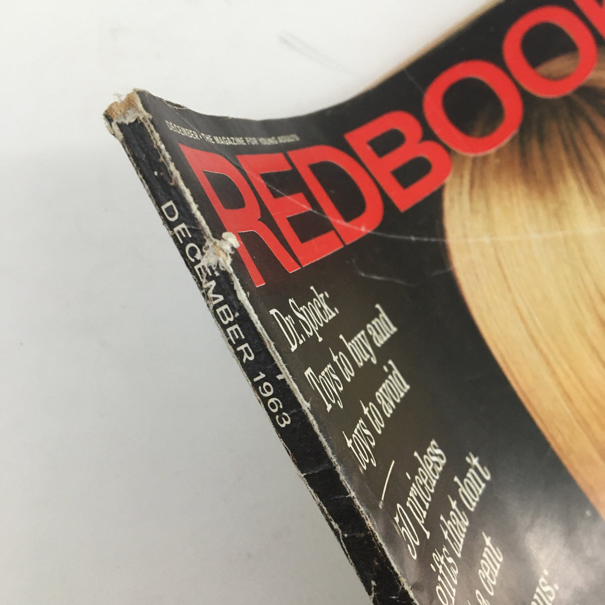 Close-up of the spine of the Redbook Magazine December 1963, showcasing the magazine's title, with visible wear and tear consistent with its vintage status.