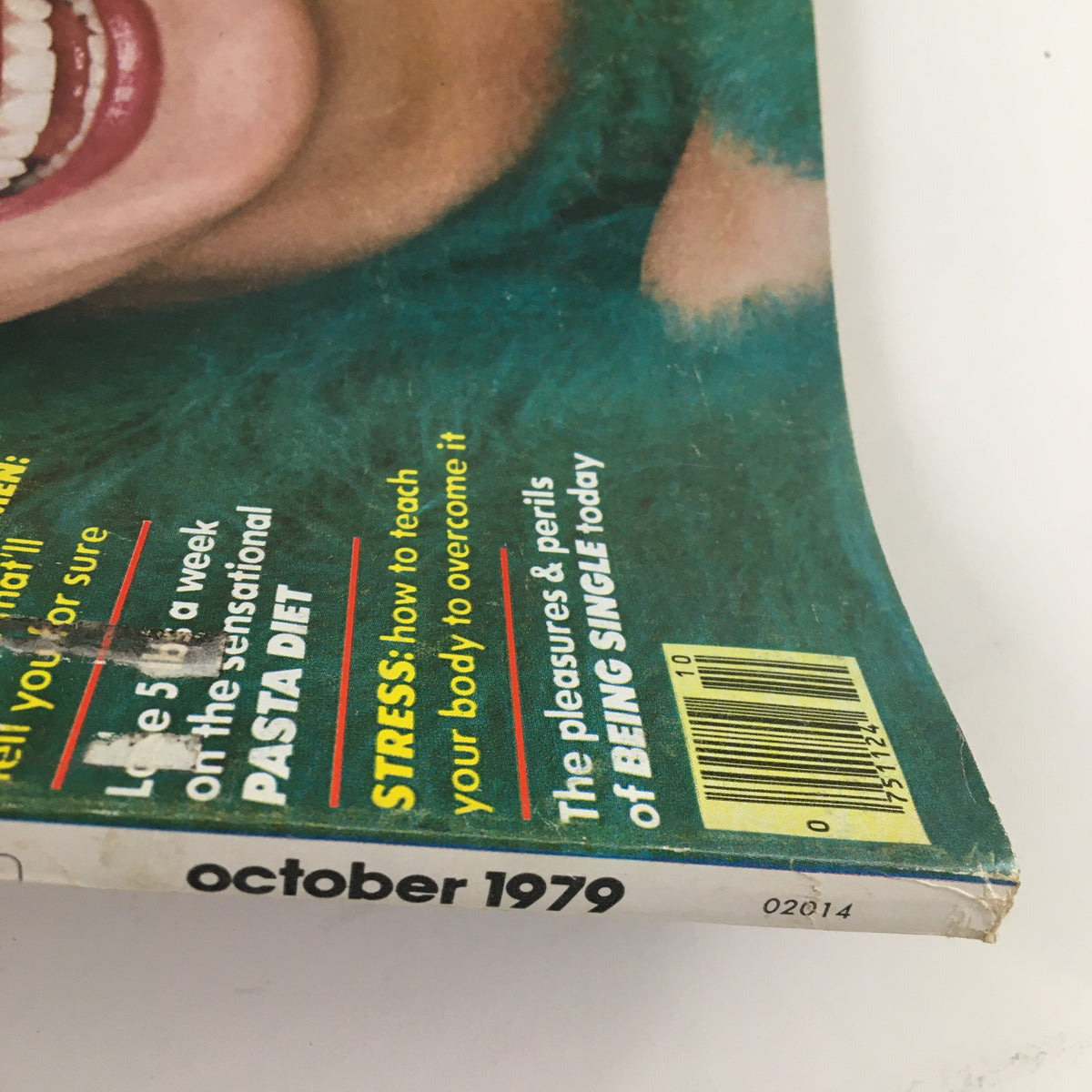 Bottom corner of Mademoiselle Magazine, October 1979, titled 'The Pleasures & Perils of Being Single Today'. Shows the edge with publication date and additional text about dating and dieting.