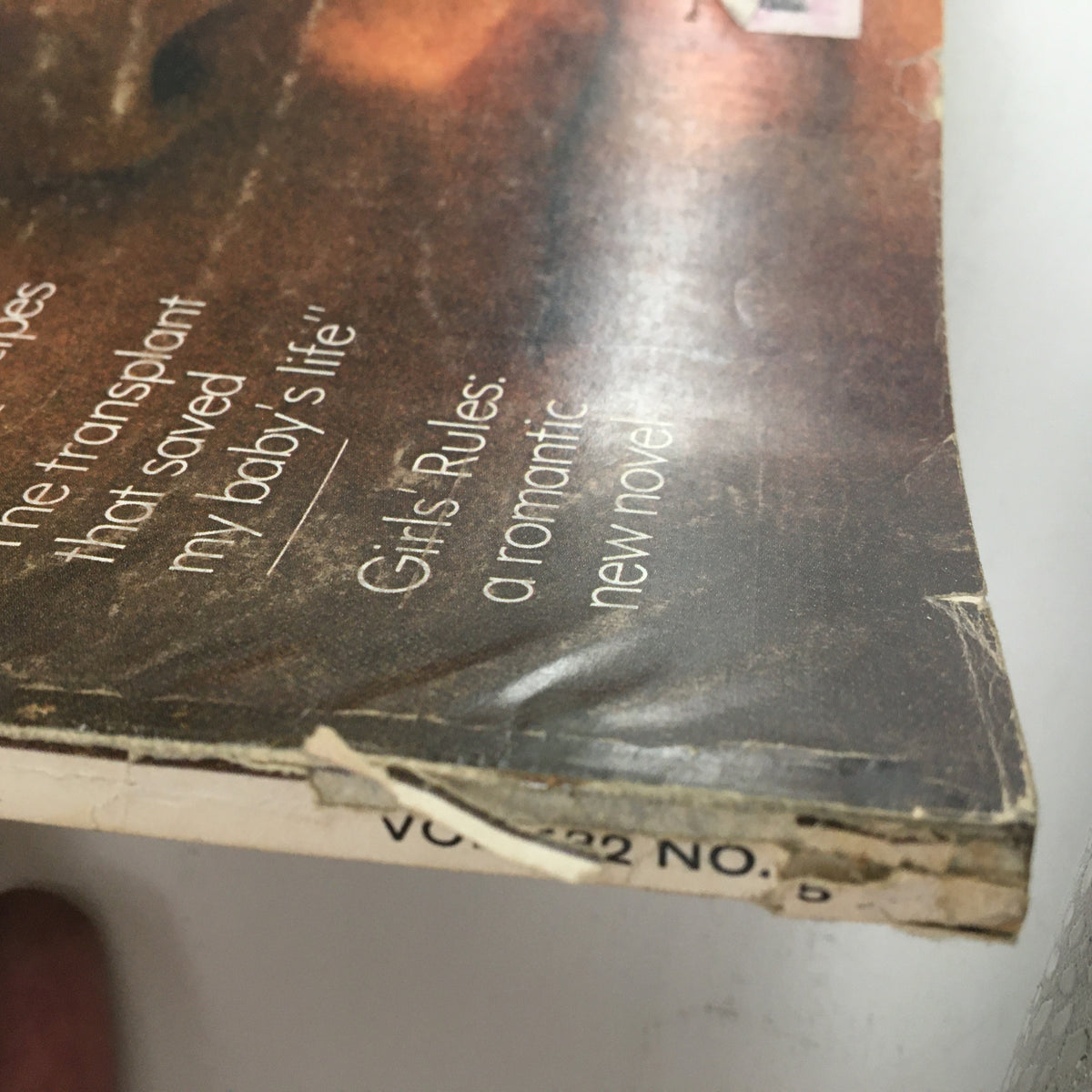 close-up of the spine of Redbook Magazine March 1969, displaying the wear and listing title articles on the cover, including features on relationships and cooking.