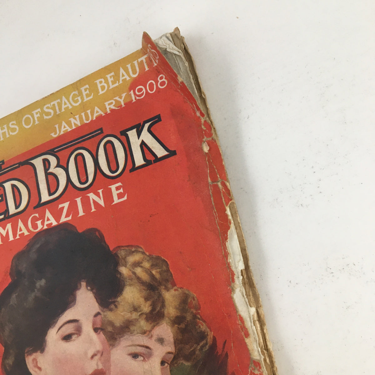 Side view of The Redbook Magazine January 1908 showcasing the title and vintage binding with signs of age.