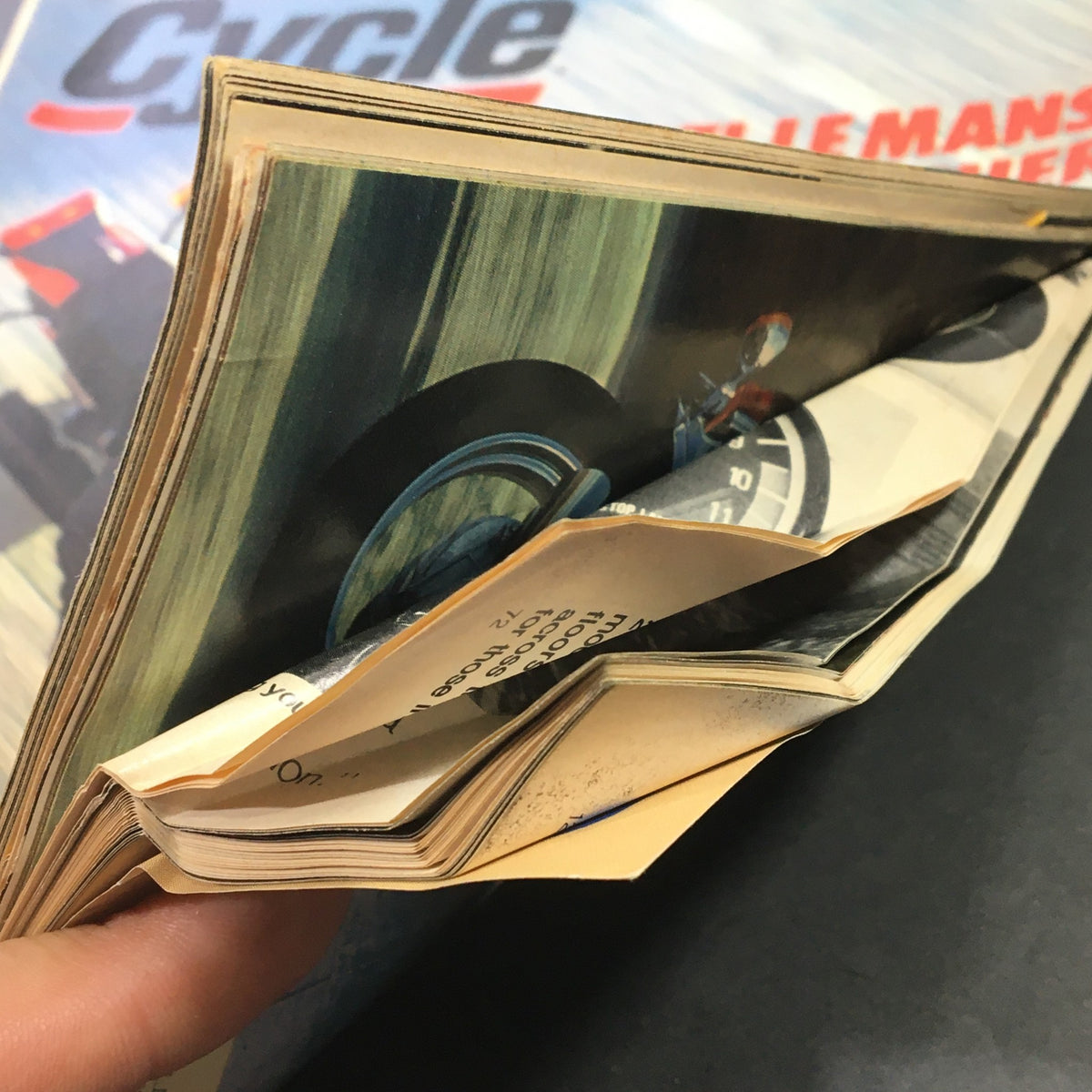 Close-up view of the spine of the July 1980 Vintage Cycle Magazine displaying folded pages, highlighting its condition as a collectible featuring Moto Guzzi Le Mans 949cc and Suzuki PE175T.