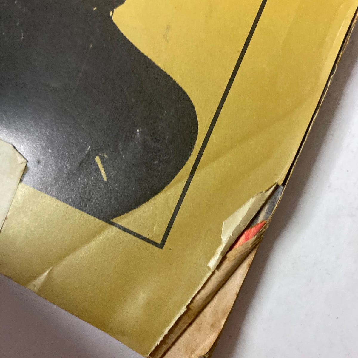 Close-up view of the top corner of Down Beat Magazine July 2, 1964 30th Anniversary Issue 1934-1964 showing cover damage including creases and tape.